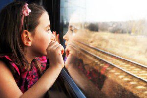 A young girl gazes out the window while taking a ride on the Blue Ridge Scenic Railway.